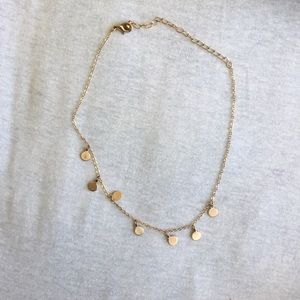 Chocker with dangly gold circle off of it